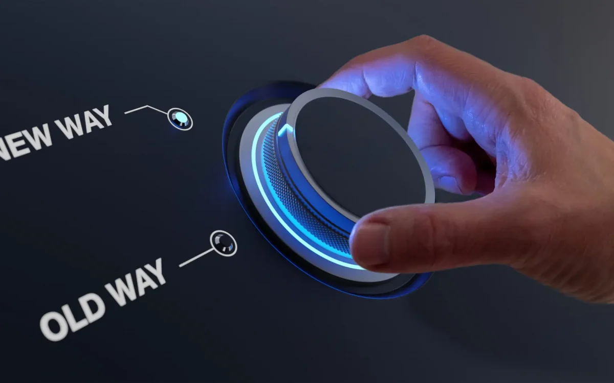 Change management concept for digital transformation or corporate organizational shift. Hand turning knob with choice between old way and new way. Forward thinking, vision and strategy.